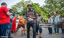 NEW DELHI, INDIA - 2021/05/31: A young man receives a food package and a facemask during food distribution by the Baba Balak Nath Mandir Hindu institution.
The Baba Balak Nath Mandir, Hindu devotees distribute food packages and masks to daily wagers, homeless and other people affected by the Covid-19 lockdown at Gol Dak Khana Roundabout. (Photo by Pradeep Gaur/SOPA Images/LightRocket via Getty Images)